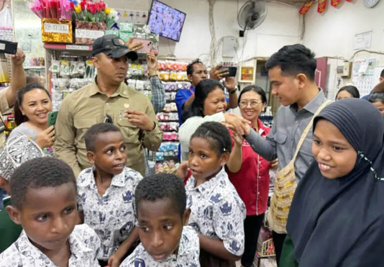 Group of children in matching uniforms in a crowded shop as adults greet them and take photos with smartphones nearby.”](")