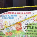Banner for a childrens education program with colorful characters and abc blocks mentioning 20262027 taped off with yellow police line tape across a doorway