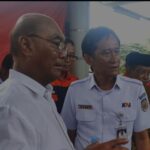 Group of men in white uniforms and name tags at a public event one badge reads bobby near an escalator