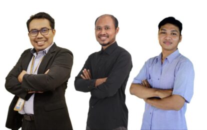 Three men stand side by side with arms crossed, smiling at the camera against a white background—group portrait of colleagues/partners,