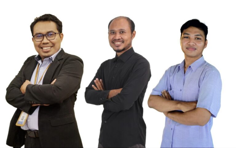 Three men stand side by side with arms crossed, smiling at the camera against a white background—group portrait of colleagues/partners,