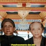 Two people stand side by side in formal black clothing in front of a ornate wooden ceiling a yellow caption is visible at the bottom in indonesian