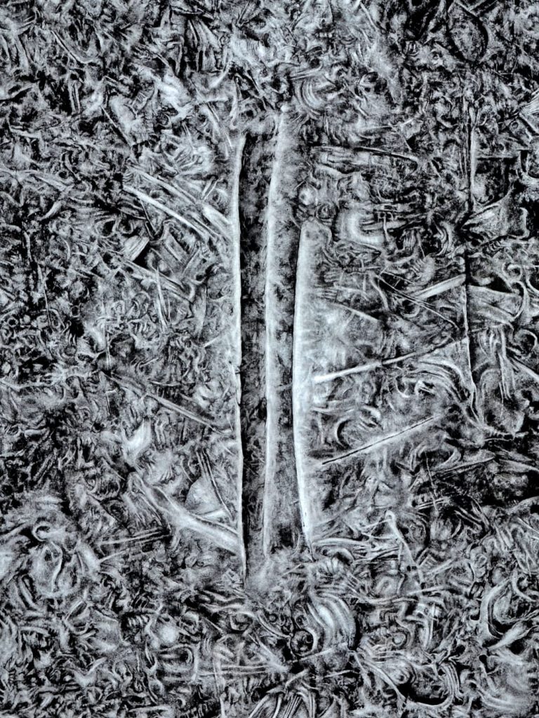 Two slender tree trunks stand side by side in a bed of textured fallen leaves, creating a vertical split in the scene.