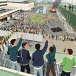 Crowd of protesters fills a city street with a burning tire pile and guards on a high wall overlooking the scene
