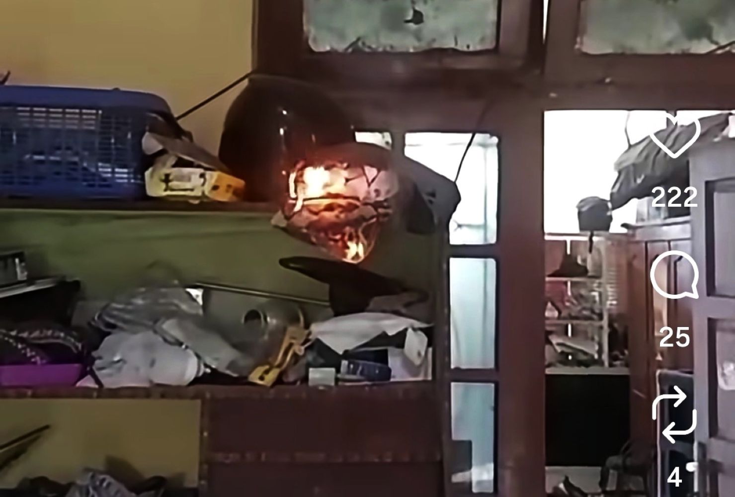 18fapi catrawarta Helmet on a cluttered shelf is burning with visible flames and smoke in a dim room