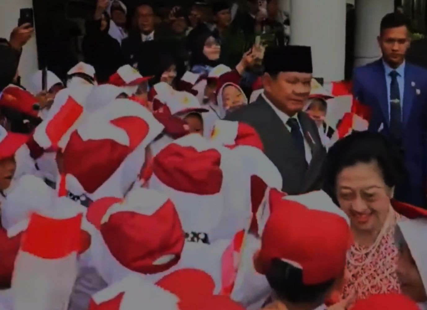 Crowd of people in red and white outfits waving indonesian flags at a public ceremony a smiling woman stands in the foreground