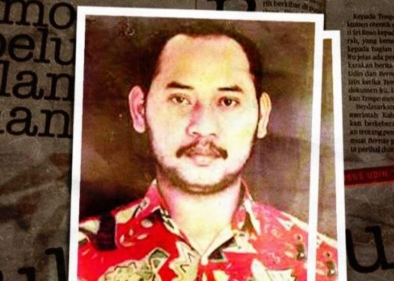 Portrait of a man with a mustache and short dark hair wearing a red patterned shirt, framed by a white border against a newspaper-like background.