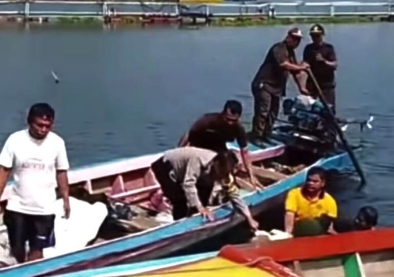 Group of men on a colorful boat near a dock, some standing and handling a long pole as others sit or stand in the boat.