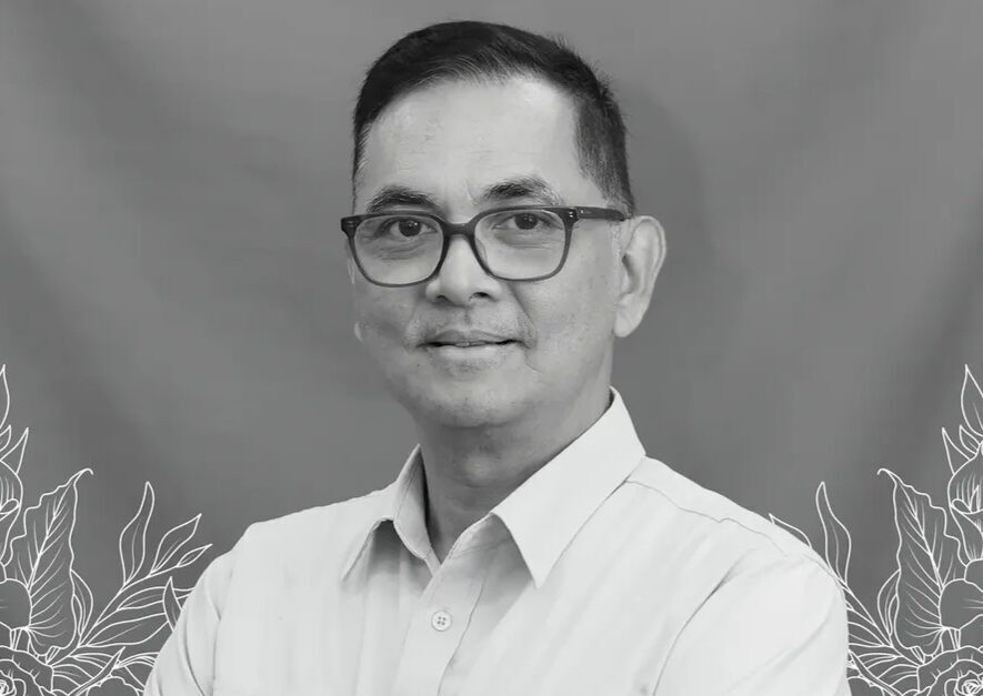 Obituary banner with a man in a light shirt and glasses on a blue gradient background with a cross and indonesian memorial text